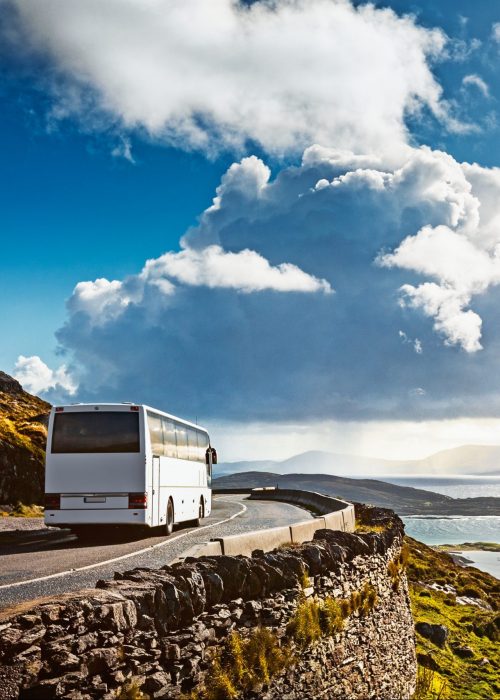 Tourist bus traveling on mountain road. Ring of Kerry, Ireland. Travel destination